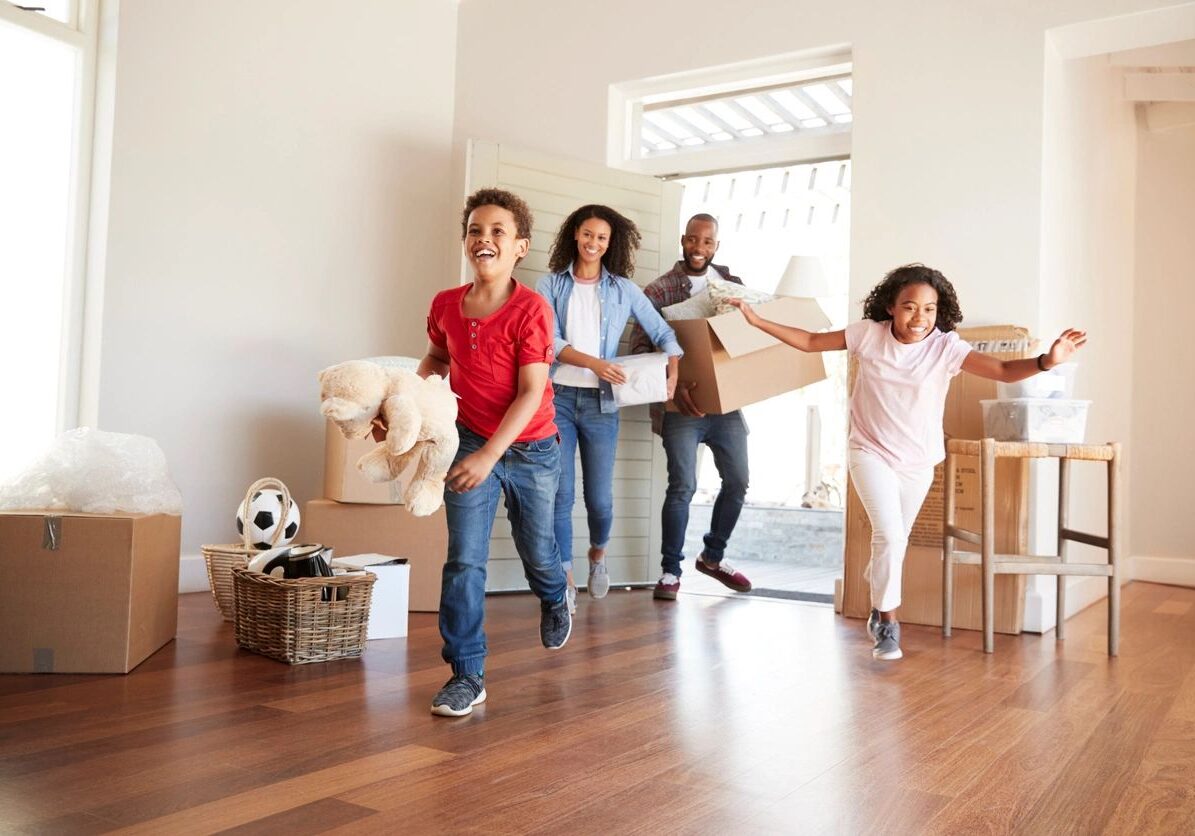 A group of people moving boxes in a room.